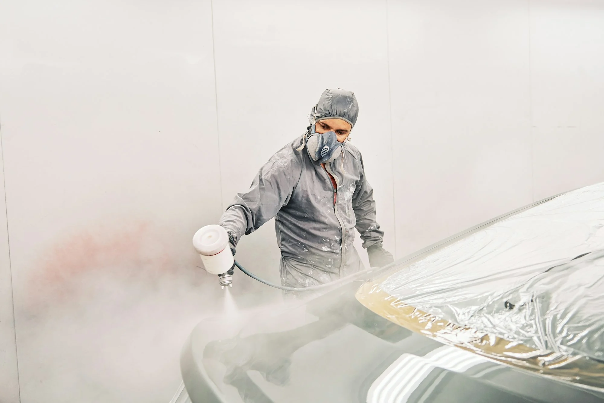 A man painting a car